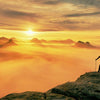 Man on Mountain Looking at Sunset