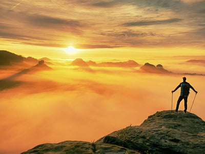 Man on Mountain looking at sunset