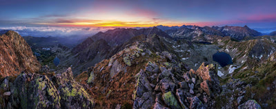 Mountain lakes with sunset above clouds